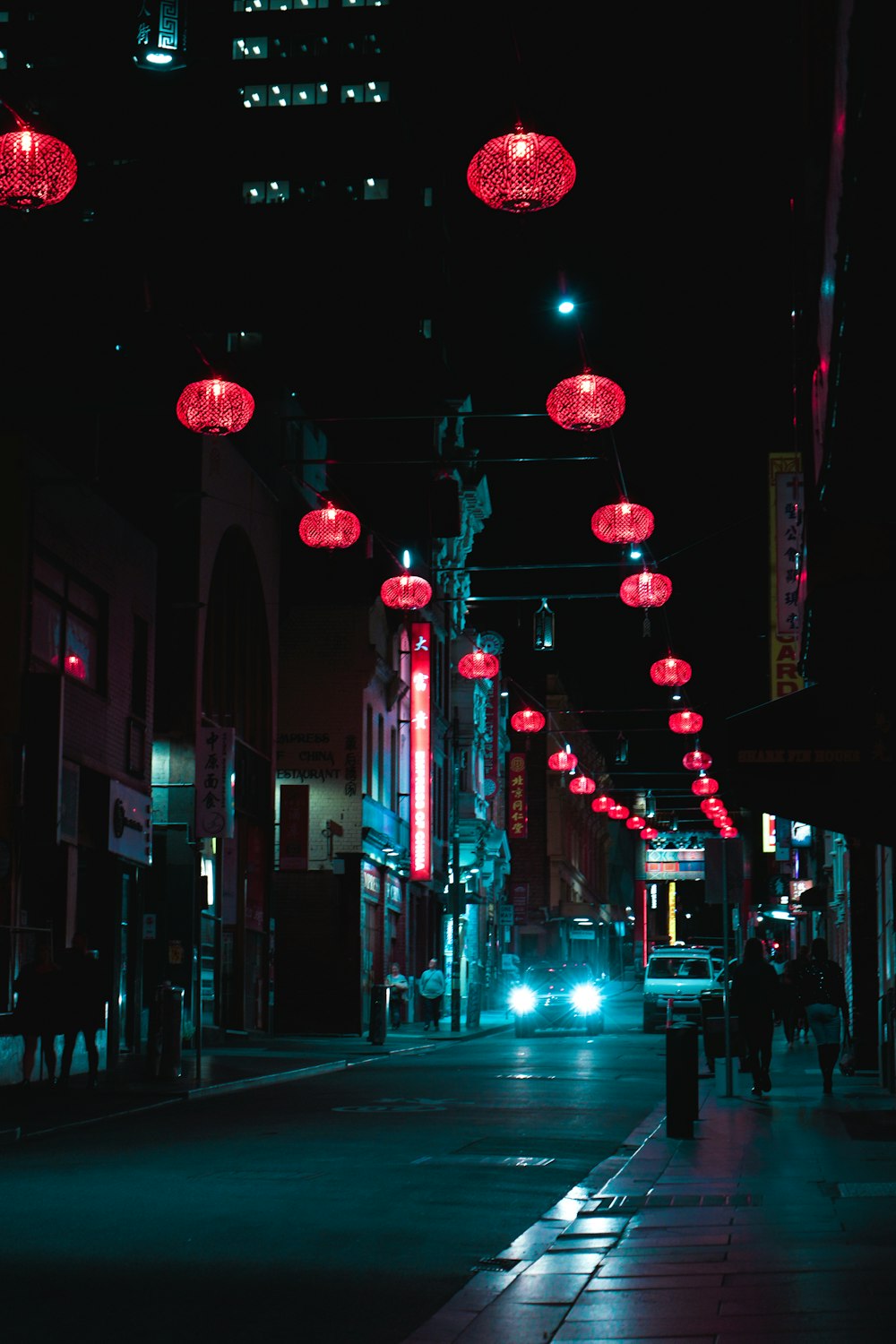 red lanterns on street during night time