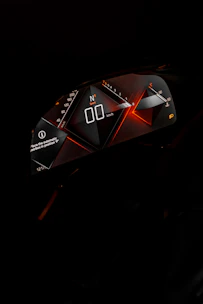 a close up of a speedometer in the dark