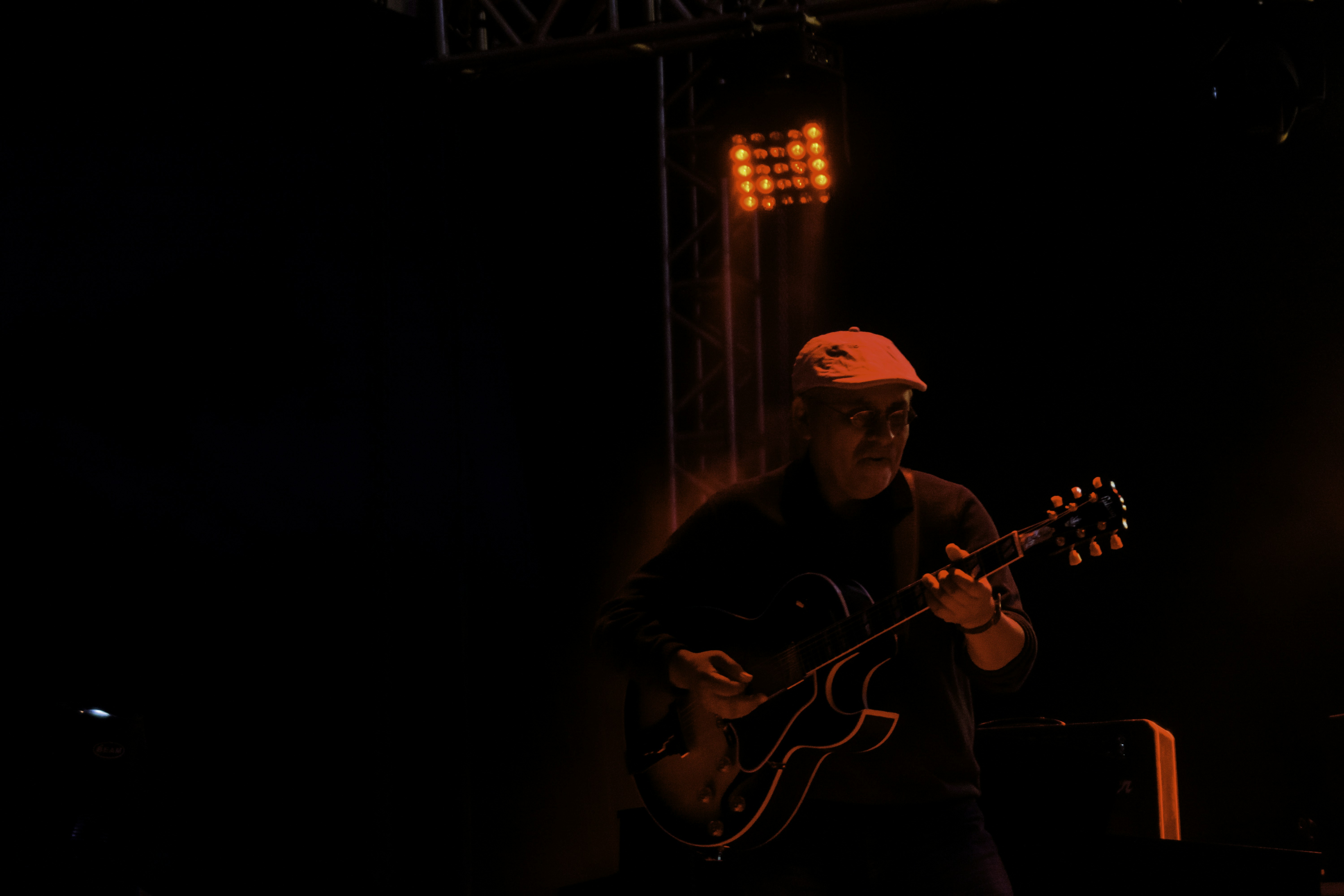 man in black shirt playing guitar