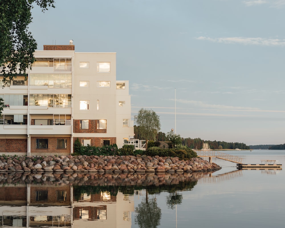 beige concrete building near body of water during daytime