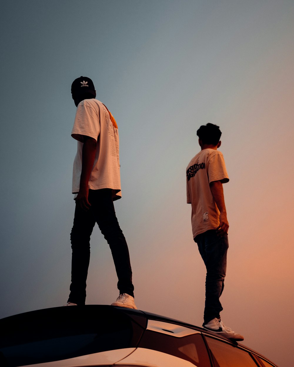 man in white dress shirt and black pants standing beside man in white dress shirt