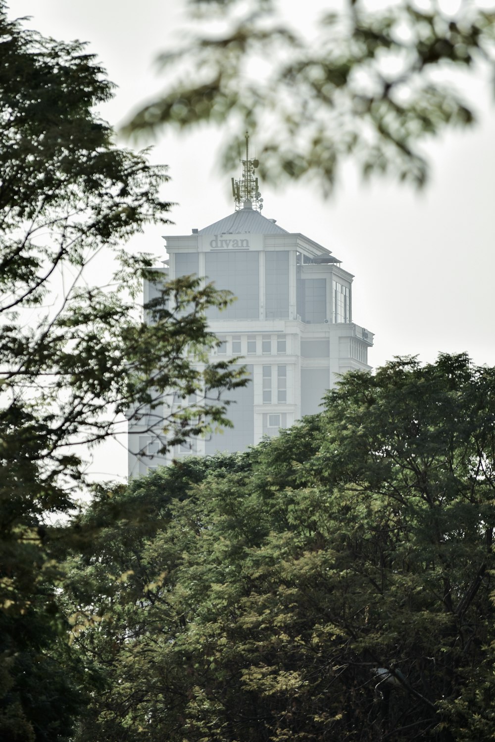 white concrete building surrounded by green trees during daytime