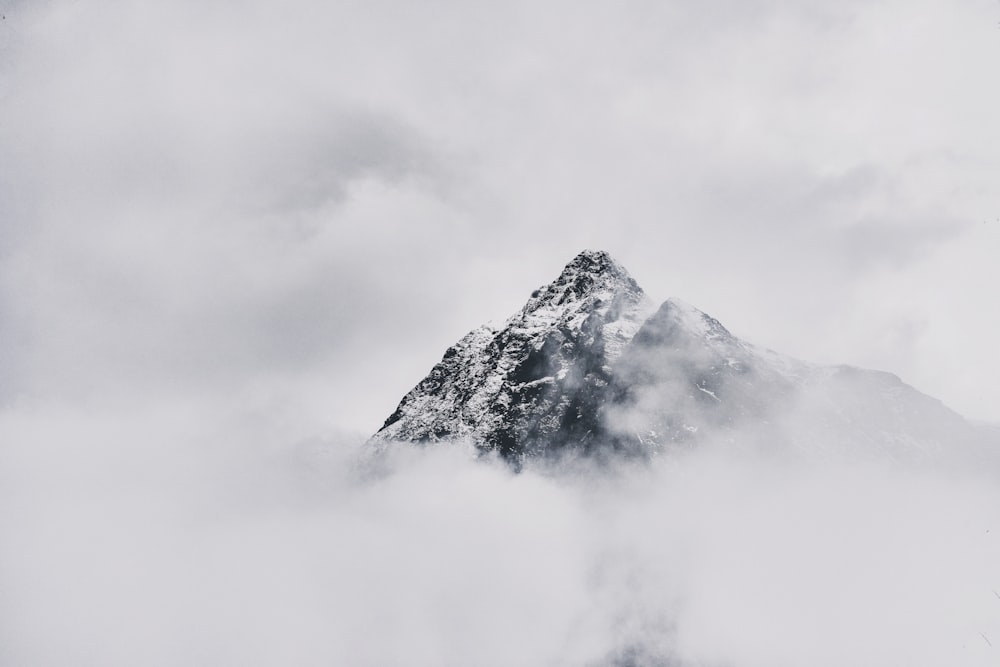 snow covered mountain under cloudy sky during daytime