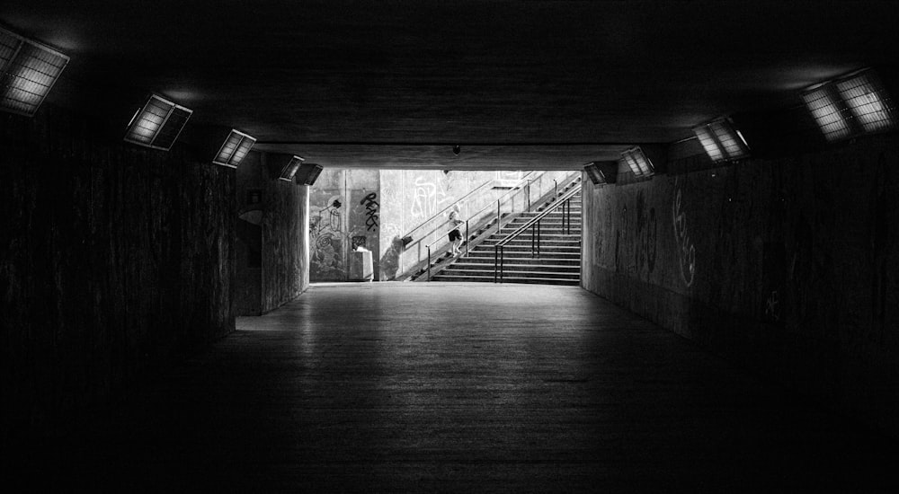 grayscale photo of a tunnel