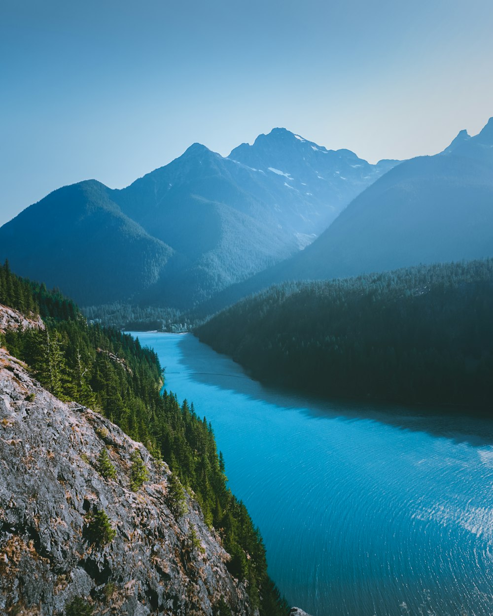 lake in the middle of mountains during daytime