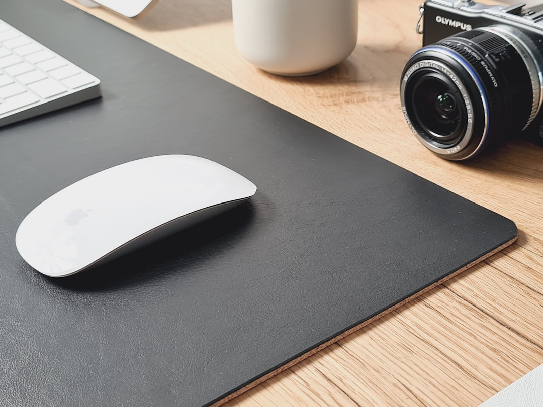 white and black computer mouse on black mouse pad