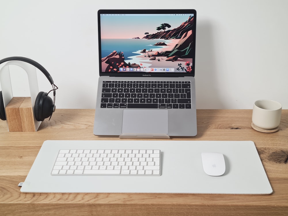 macbook pro beside black headphones