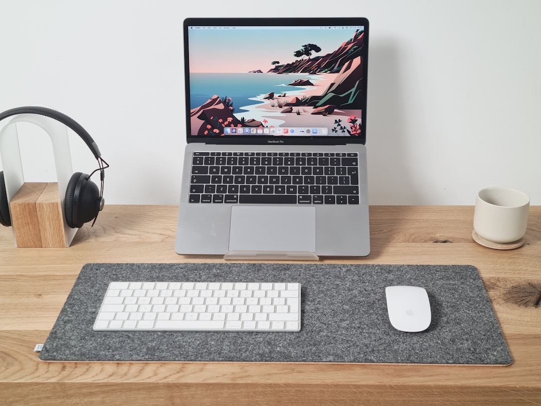 macbook pro beside apple magic keyboard and apple magic mouse