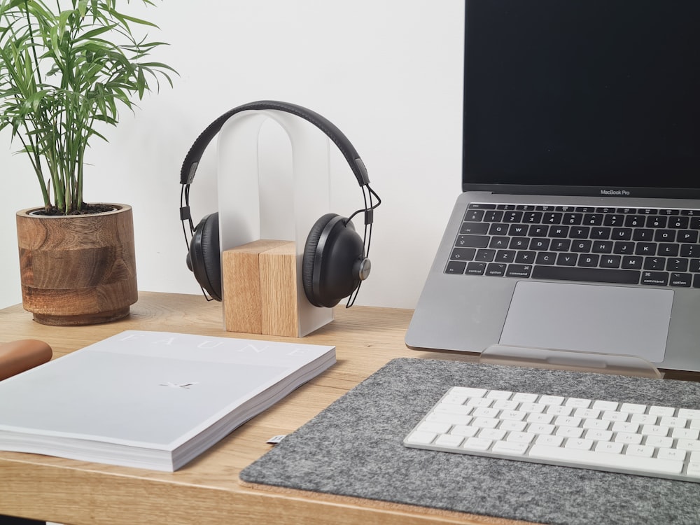 black headphones on macbook pro