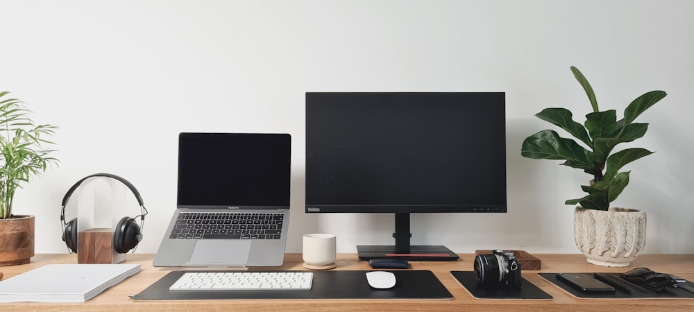 black flat screen computer monitor on brown wooden desk