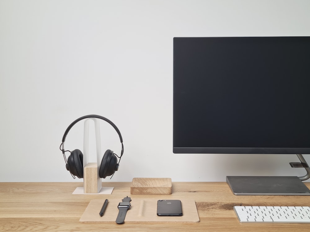 black and silver headphones on brown wooden table