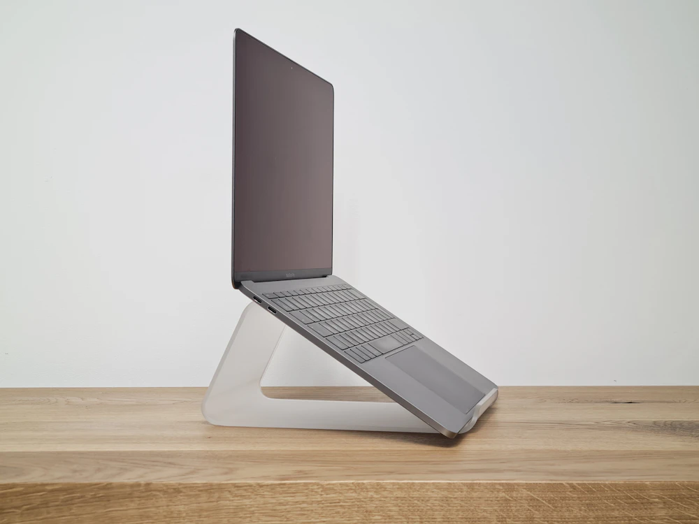 Minimalist white laptop stand side view