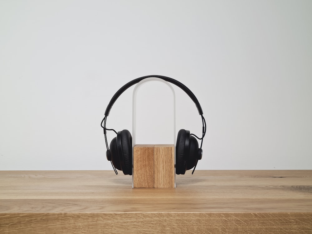 black headphones on brown wooden box