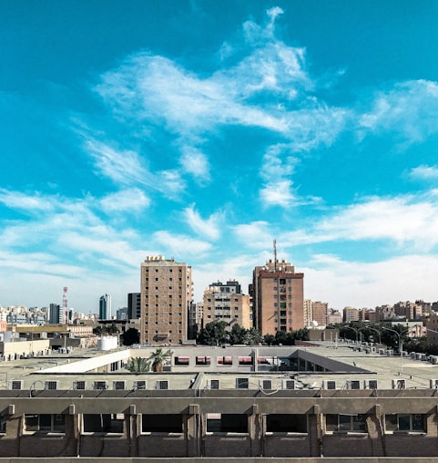 white and brown concrete building under blue sky during daytime