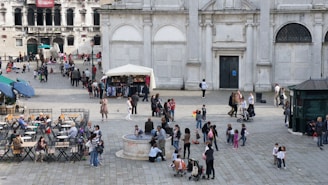A bustling city square with people engaging in various activities.