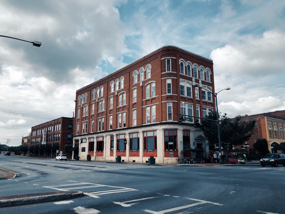 brown concrete building under cloudy sky during daytime