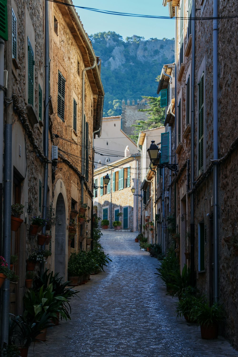 empty street between concrete buildings during daytime