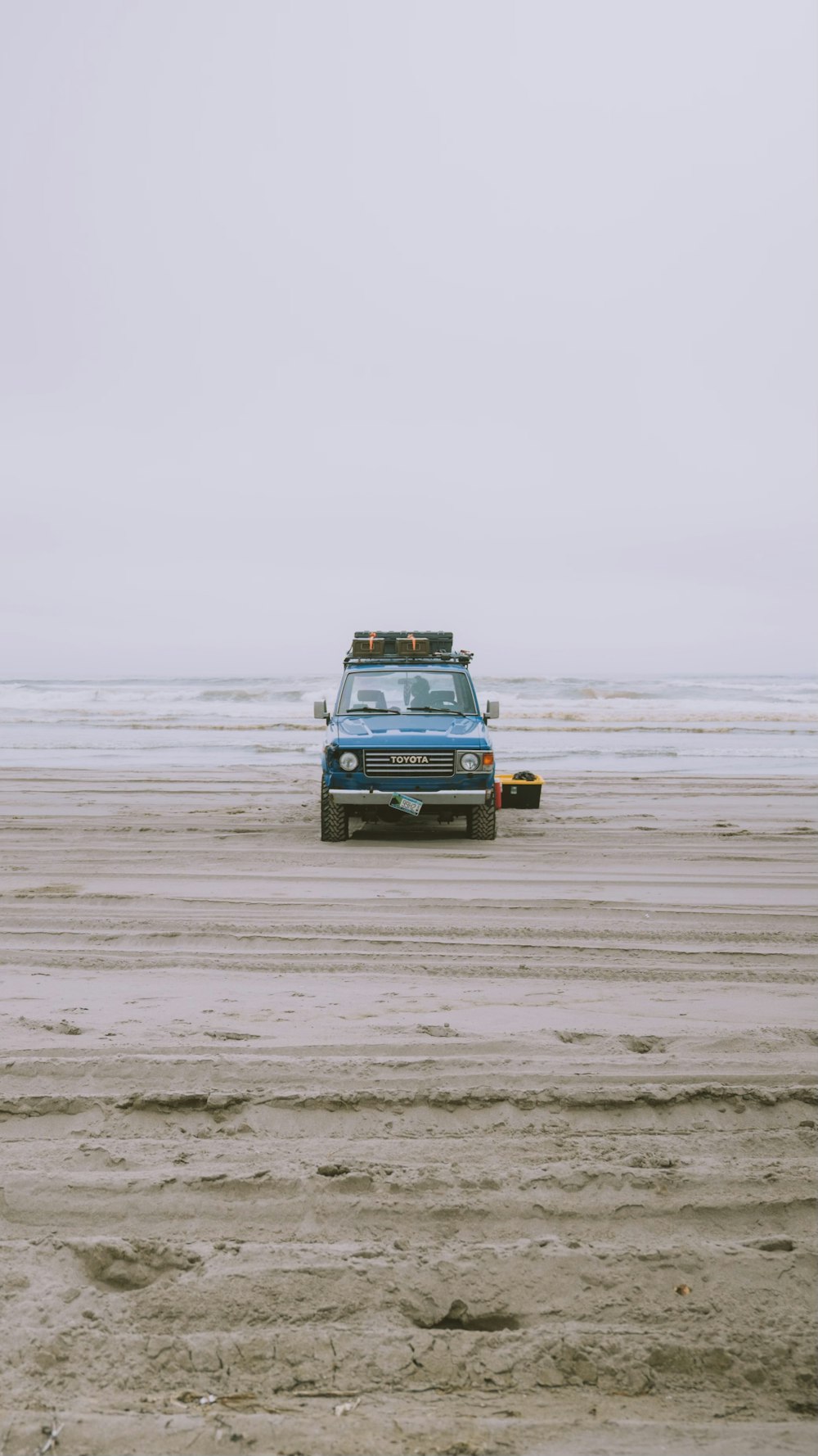 blue car on beach during daytime