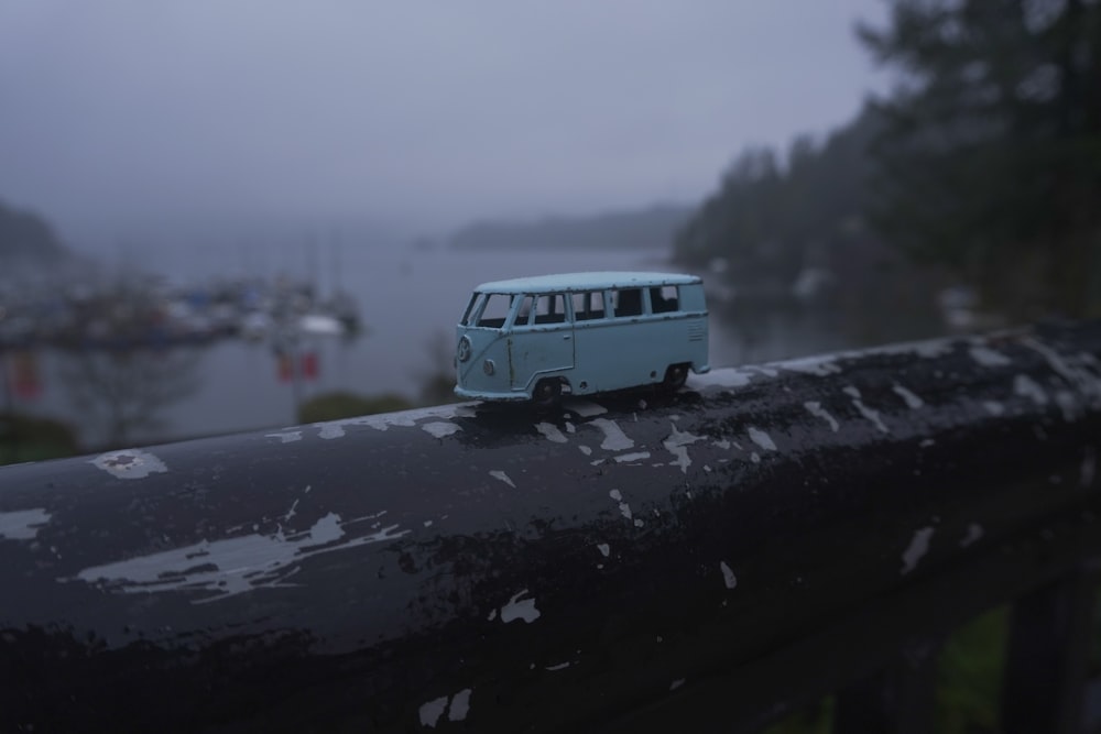 white and blue van on snow covered ground during daytime