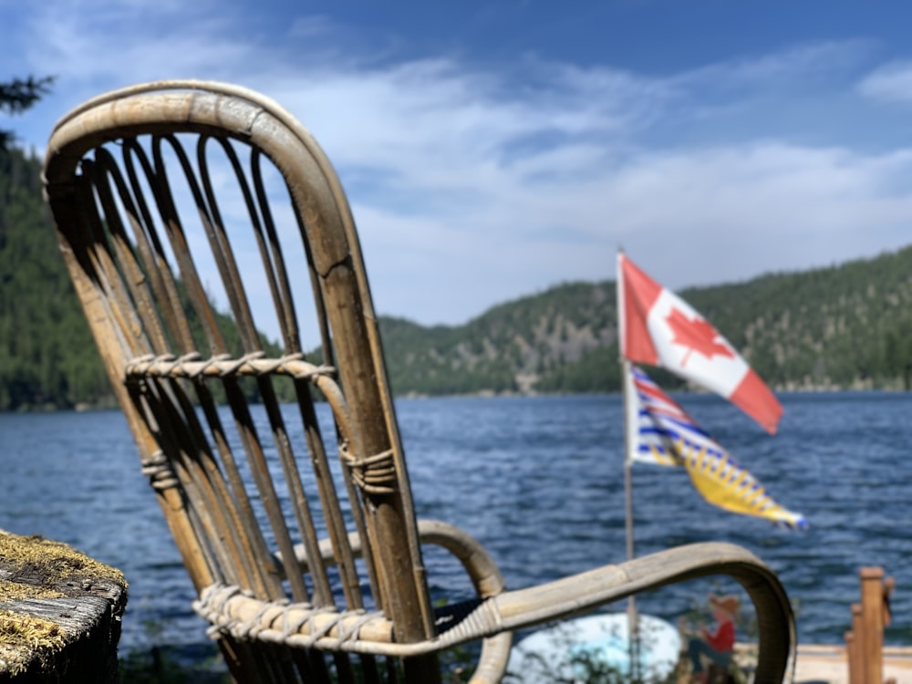 brown wooden chair near body of water during daytime