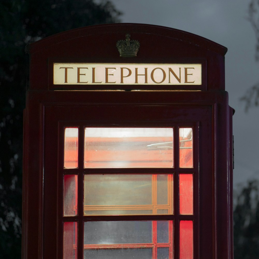 red telephone booth during night time