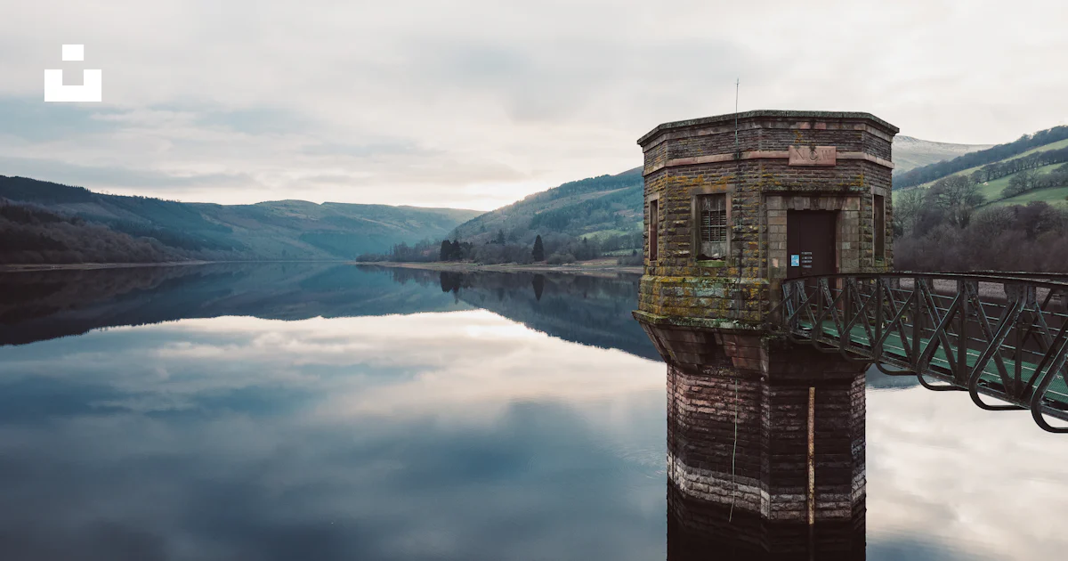 Brown concrete building on lake during daytime photo – Free Brecon ...