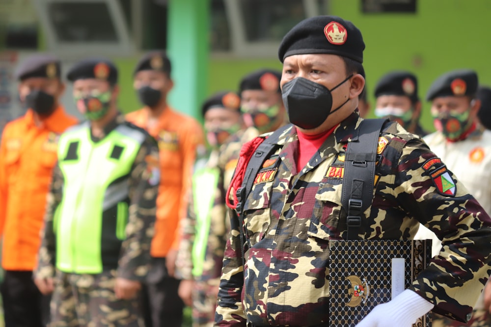 man in green and black camouflage uniform