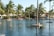 A sparkling swimming pool surrounded by lounge chairs and lush greenery.