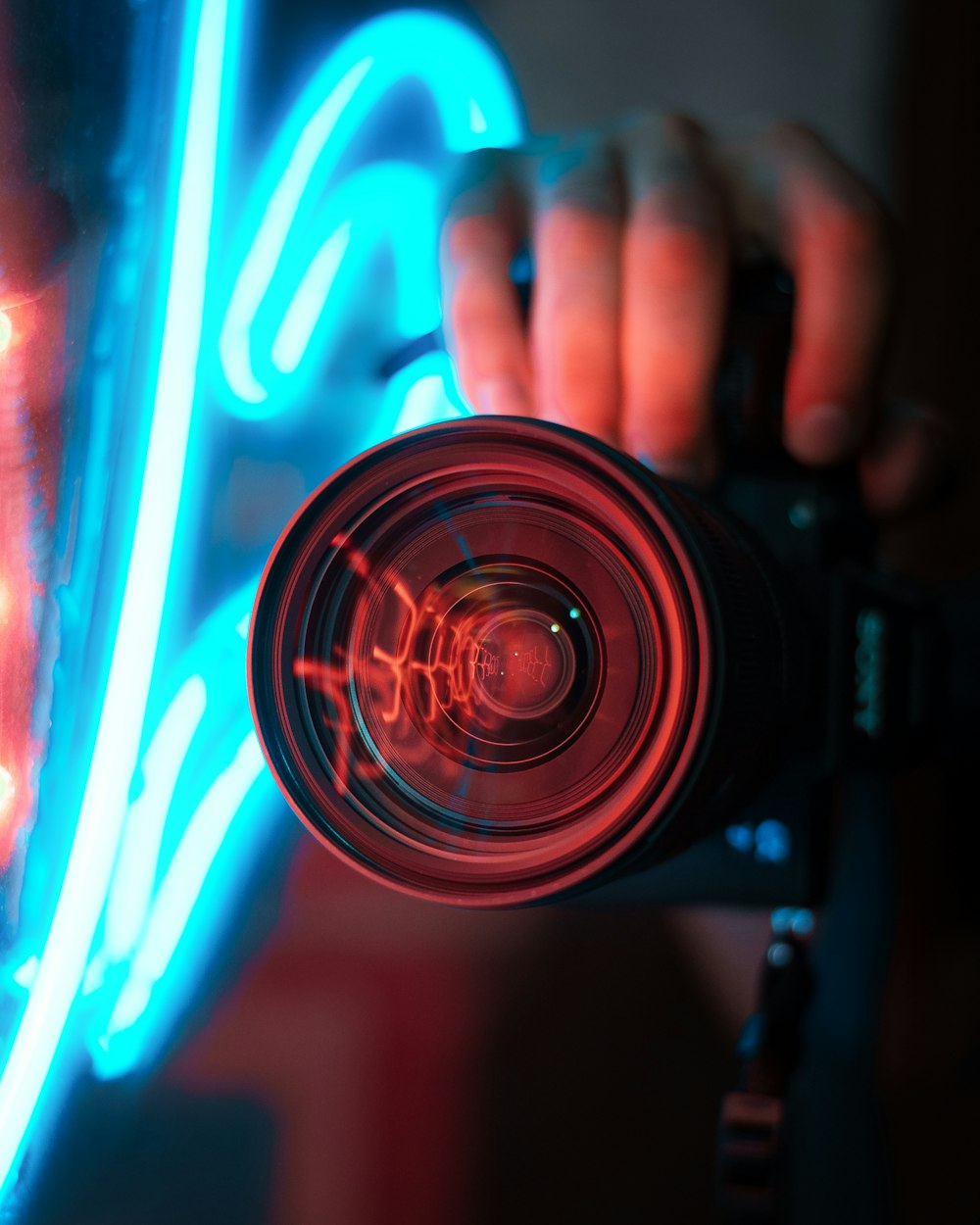 person holding black and red camera
