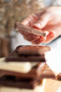 person holding brown chocolate bar