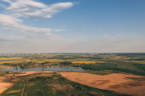 Aerial view of vast rural land with power lines and highways cutting through.
