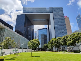 gray concrete building near green trees during daytime