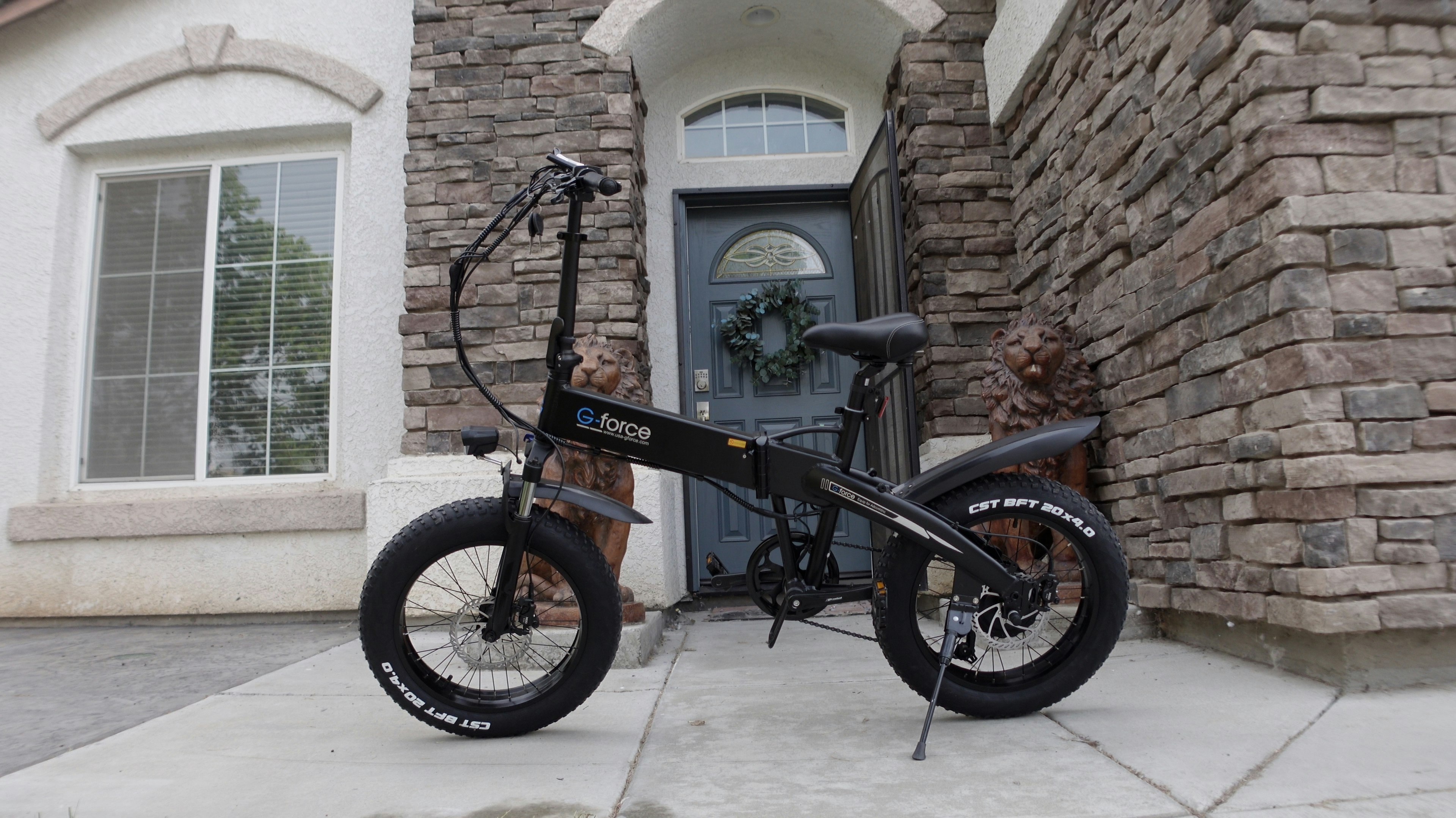 black bmx bike near brown brick wall