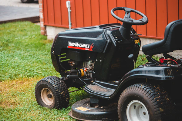 Ride-on lawn mower on green grass