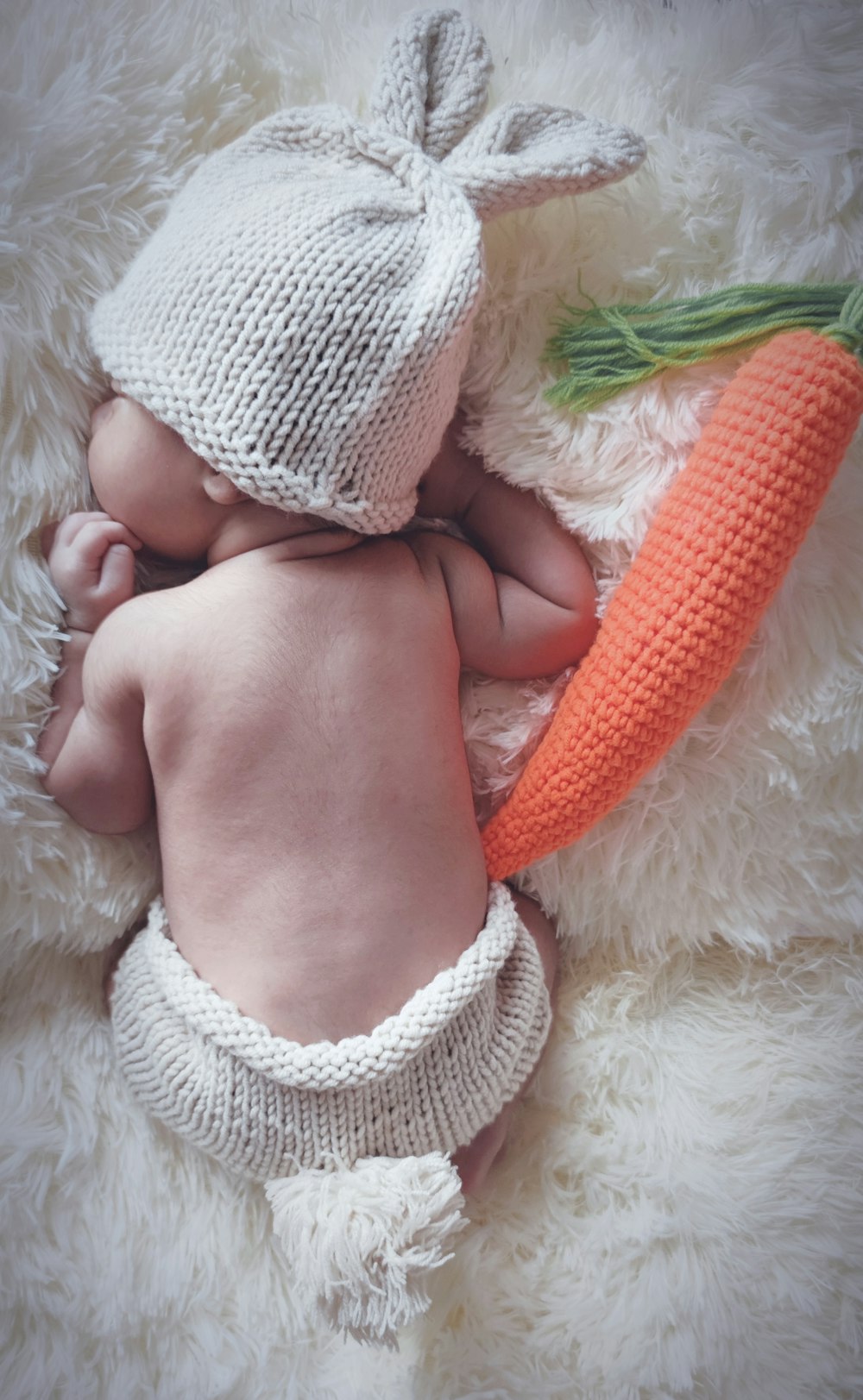 baby in white knit cap