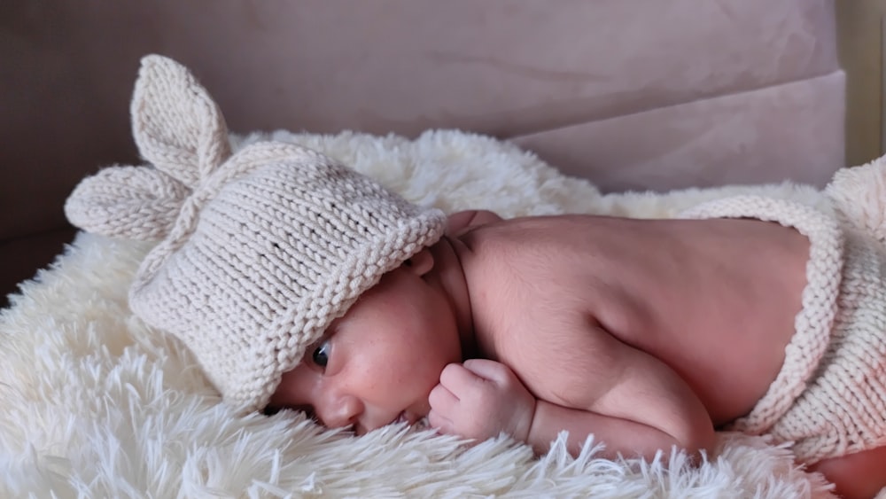 baby in white knit cap