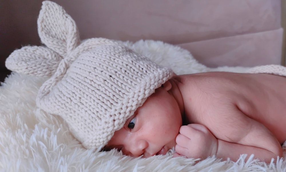 baby in white knit cap