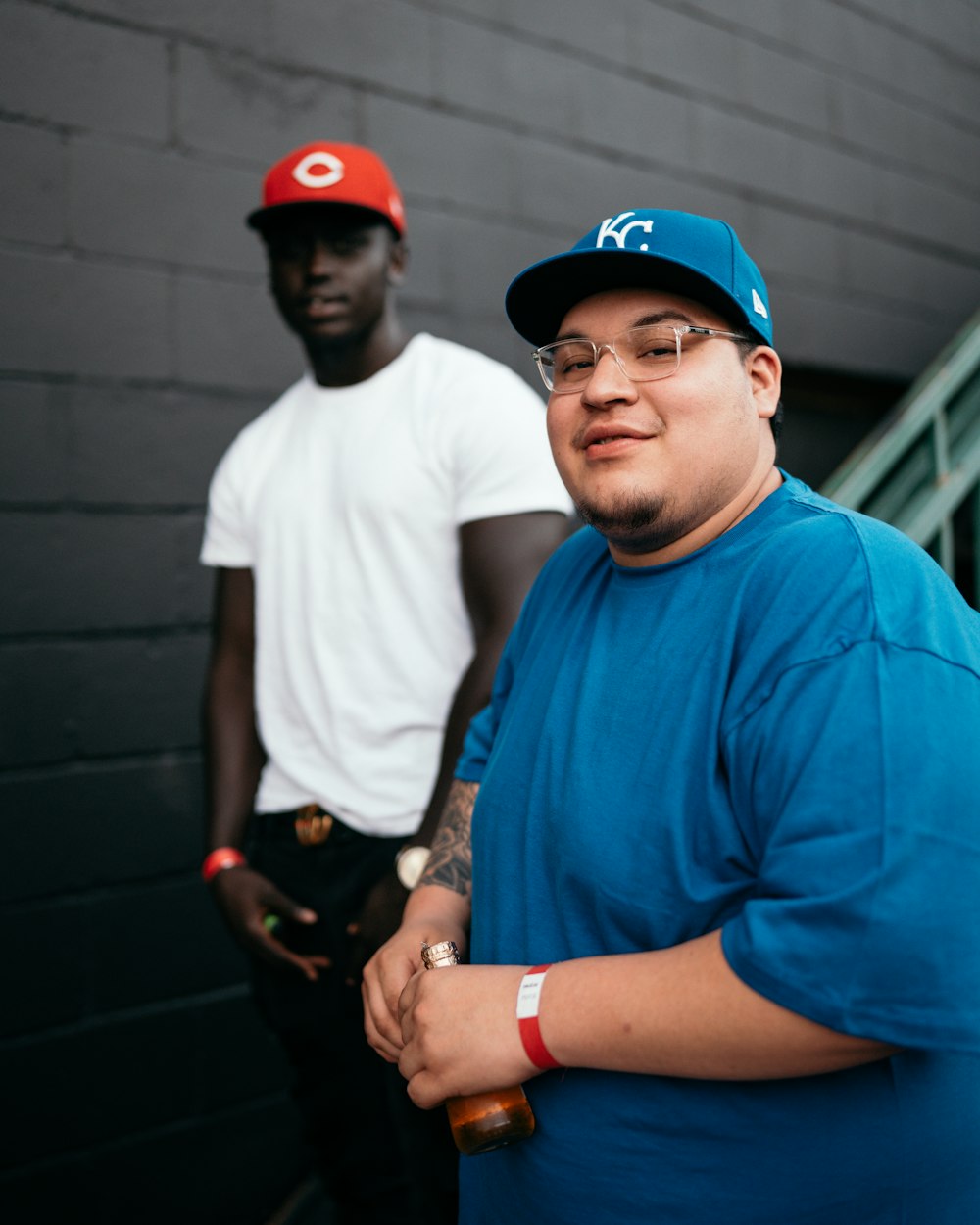 man in blue crew neck t-shirt wearing red cap