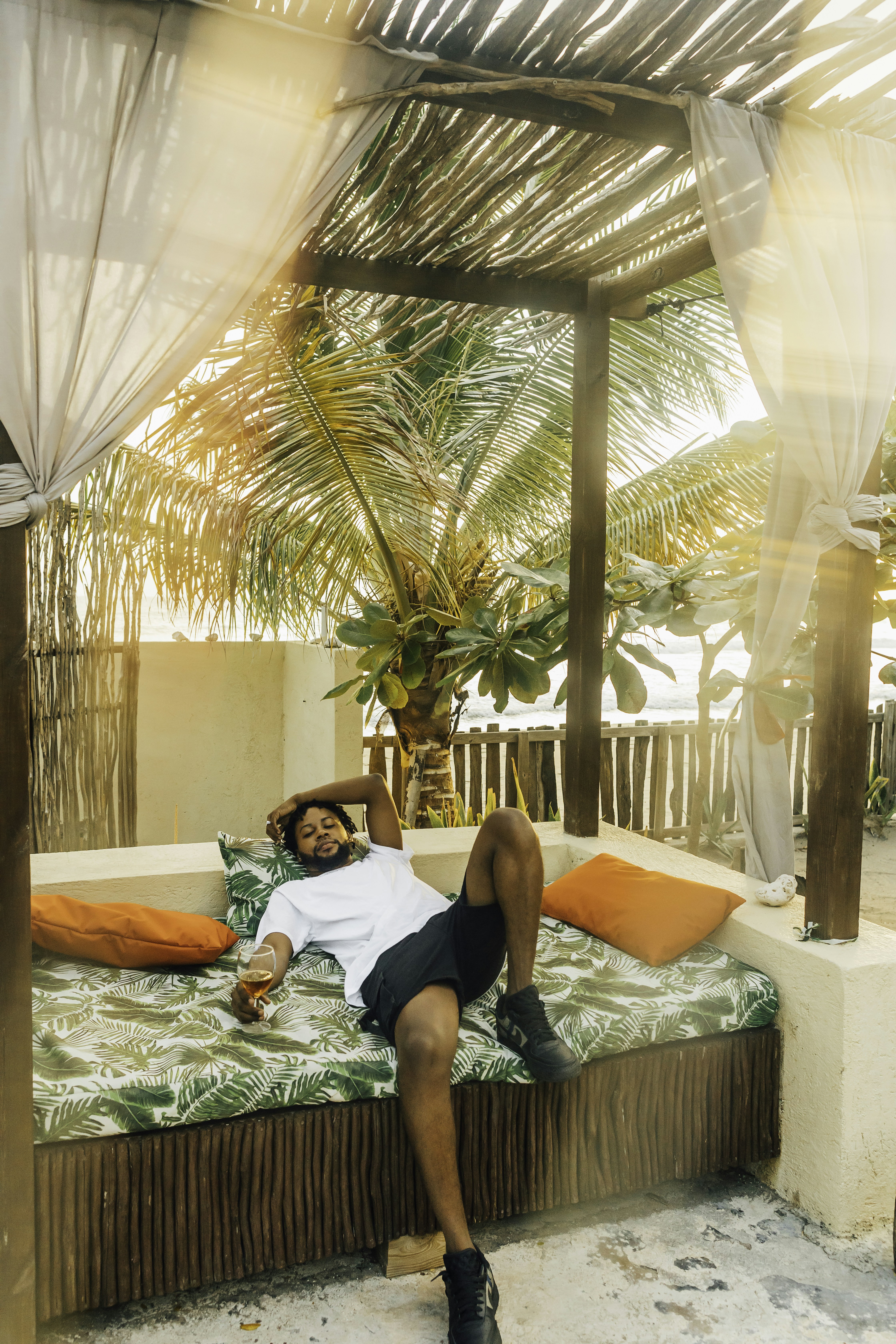 woman in black tank top and black shorts lying on bed