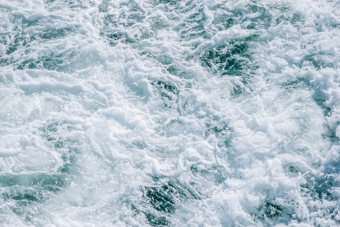 ocean waves crashing on shore during daytime