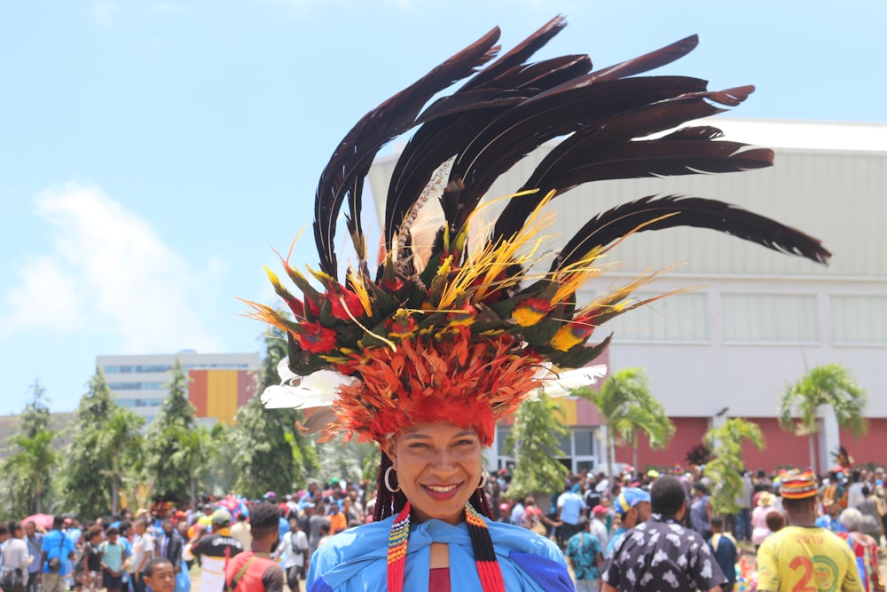 person in red yellow and black feather headdress