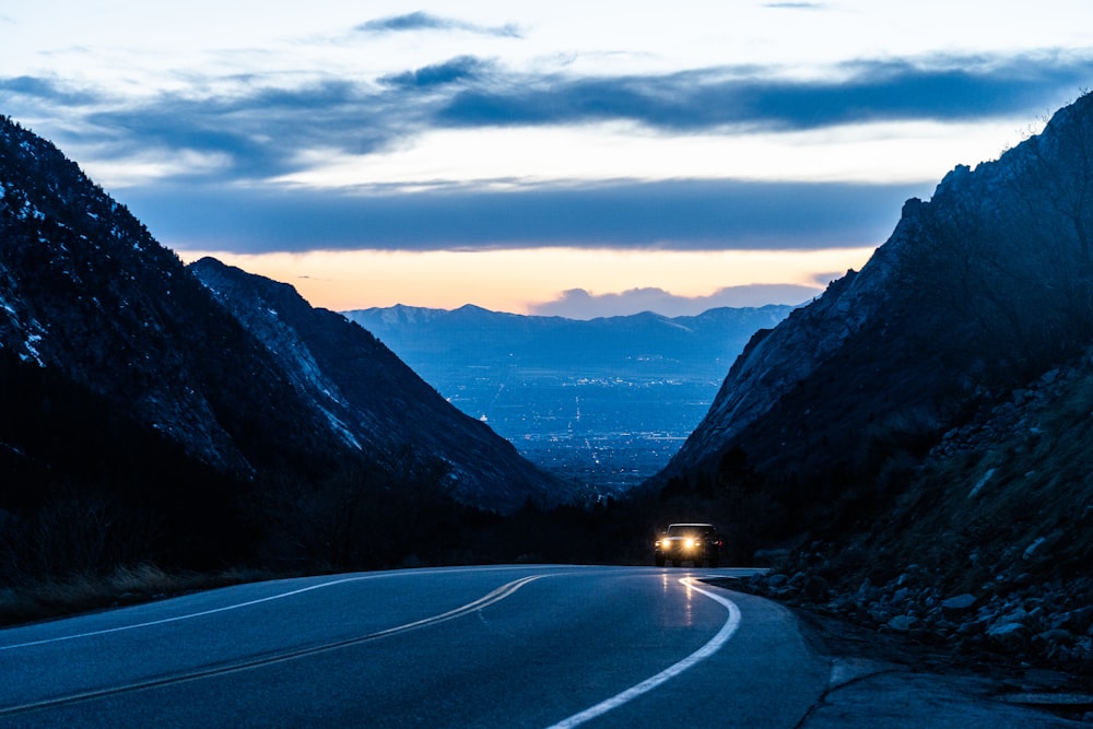 black asphalt road between mountains during daytime