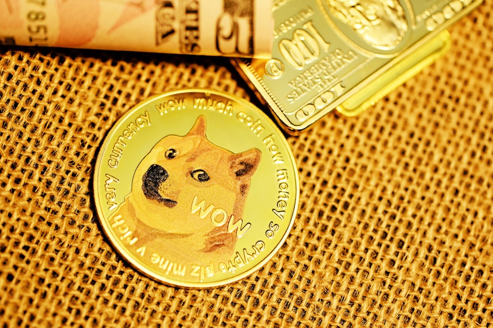 gold round coin on brown textile