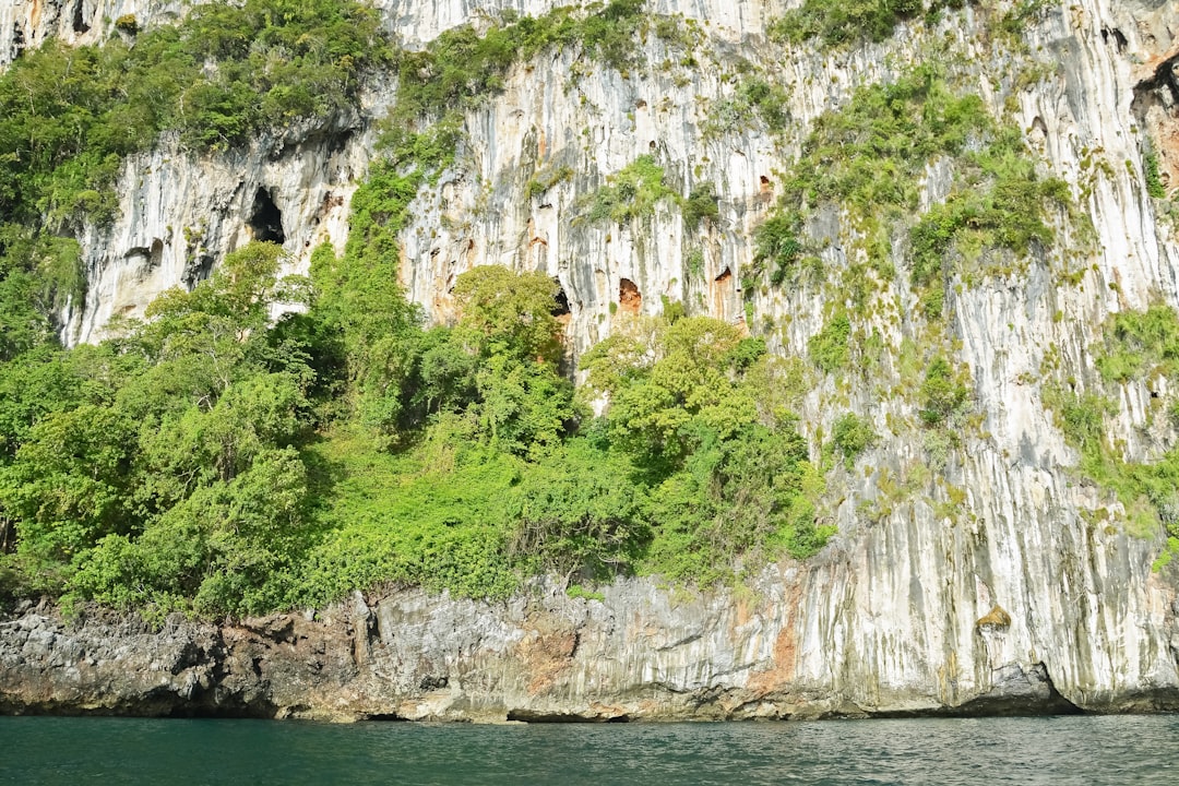 white and brown rock formation on body of water during daytime