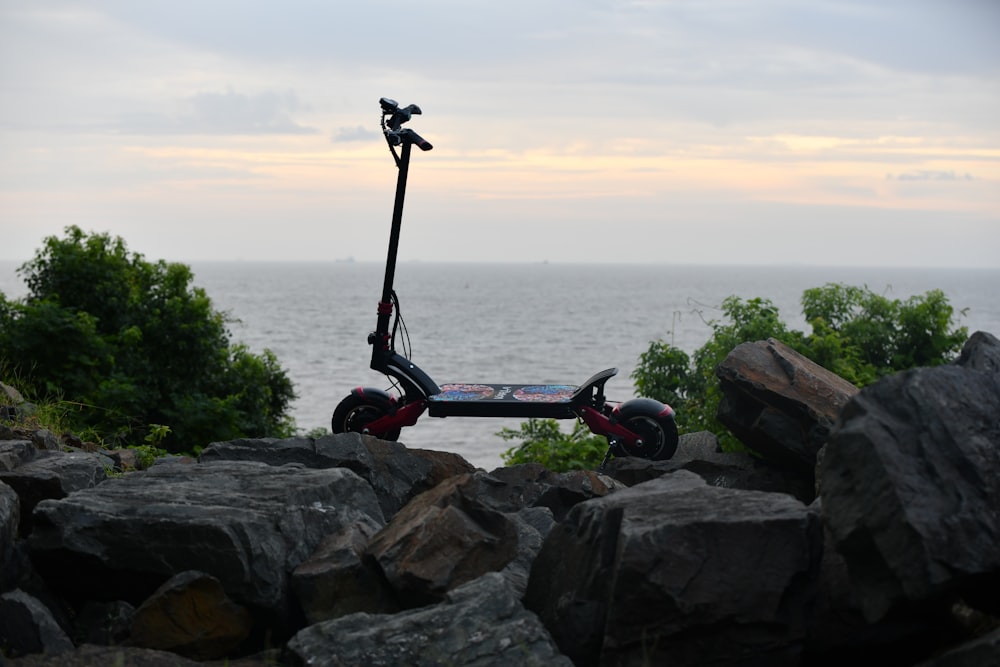 black and red bicycle on rocky shore during daytime