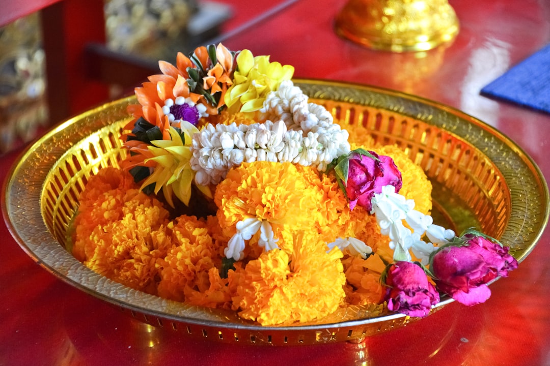 yellow and pink flowers on brown round plate