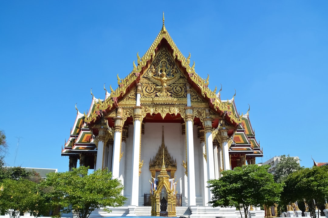 gold and white temple under blue sky during daytime