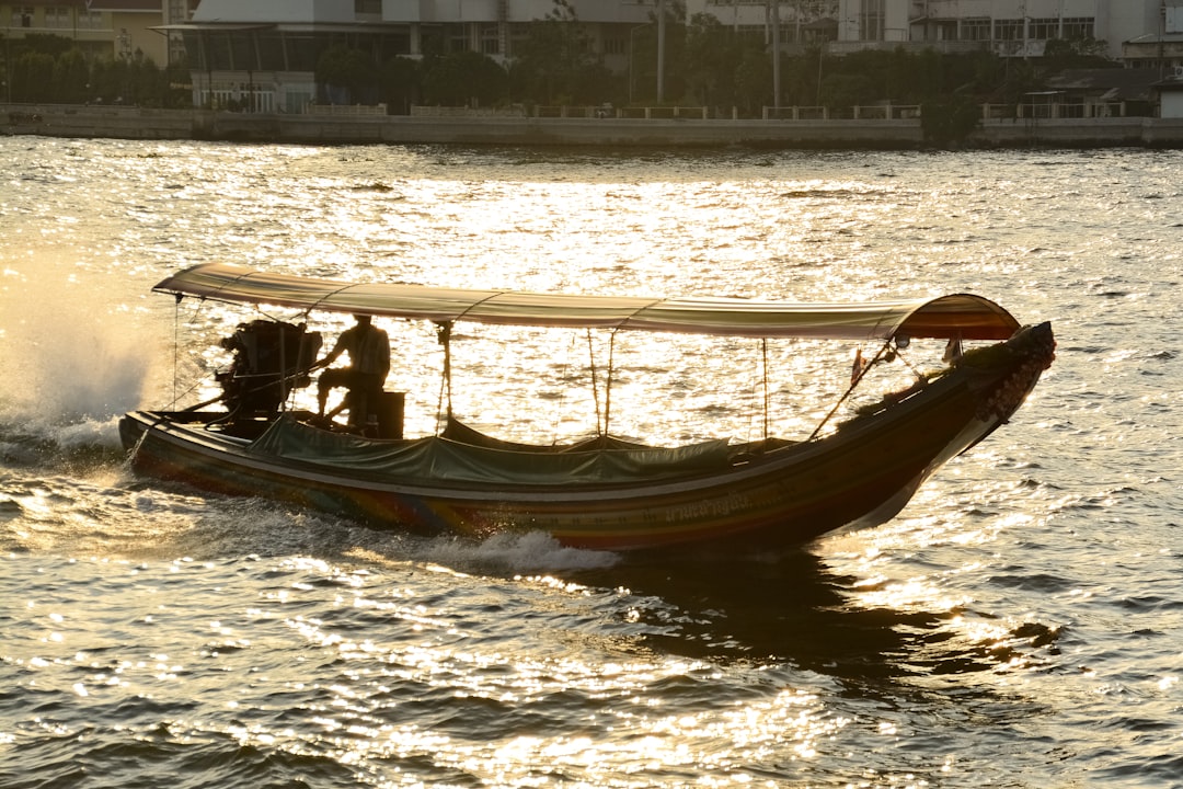people riding on brown boat on sea during daytime