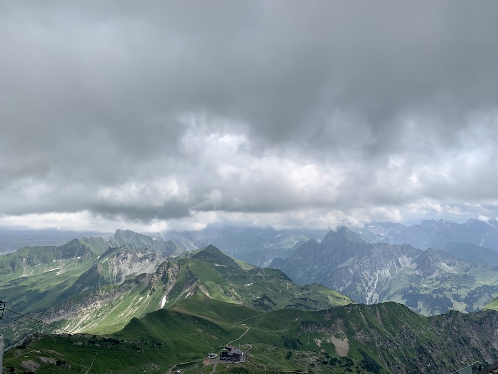 green and white mountains under white clouds during daytime