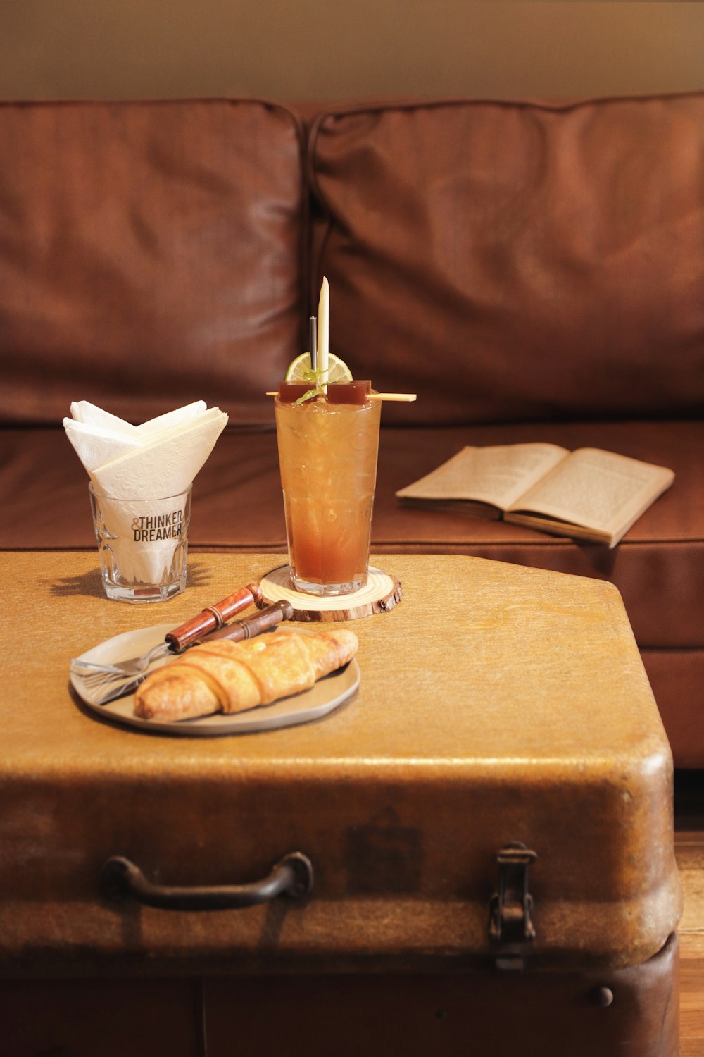 clear drinking glass with orange juice on brown wooden table